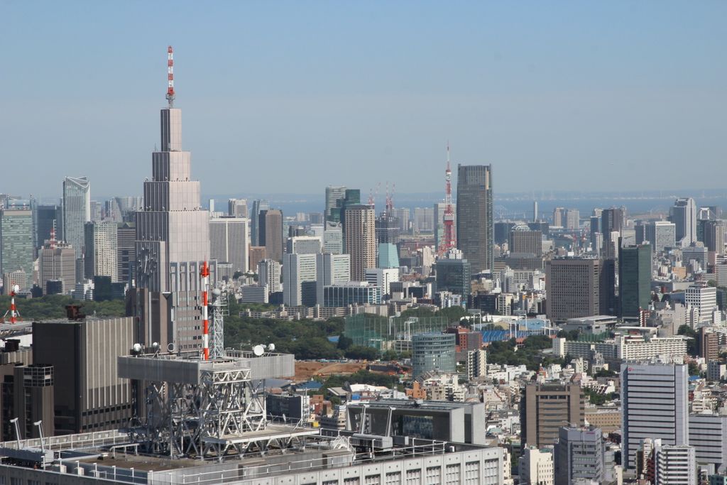 Stunning aerial view of Tokyo skyline showcasing iconic landmarks and modern architecture during the day.